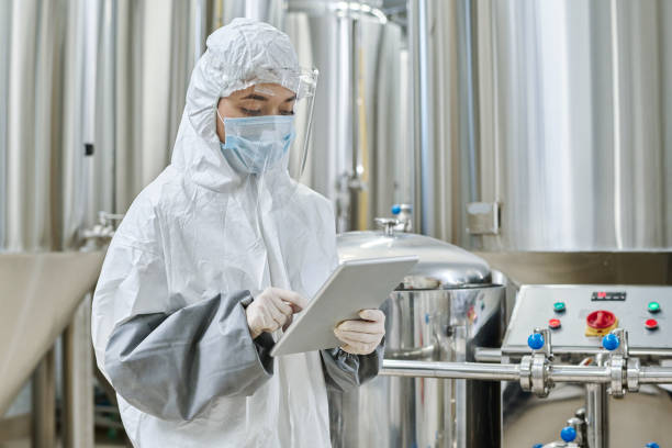 istock Engineer in protective wear working at chemical factory 1453095356