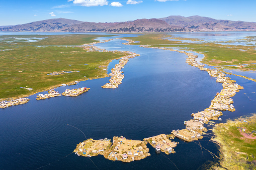 Uros Islands, Lake Titicaca, Peru - April 21, 2022; The floating islands of Uros are located in Lake Titicaca, the world's highest navigable lake, close to Puno at 3.812 metres above sea level. These floating islands are made out of reed which is an aquatic plant that grows on the surface of the Lake Titicaca.