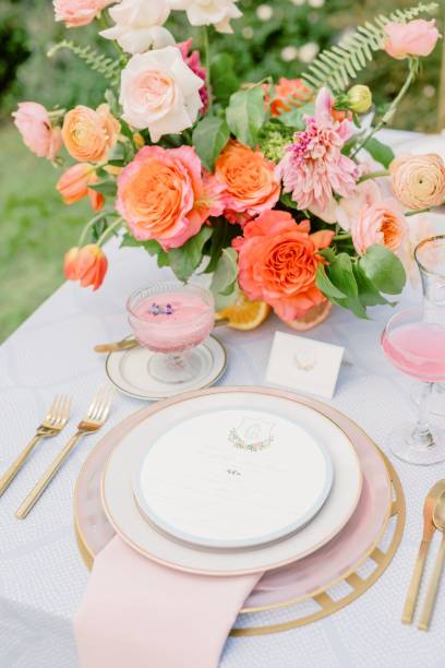 Vertical shot of an outdoor wedding table with flowers and elegant tableware