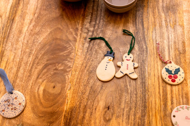 Ceramic Christmas ornaments on a wooden table.