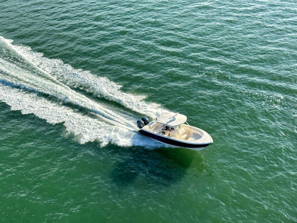 High angle view speedboat and water wake in sunny day