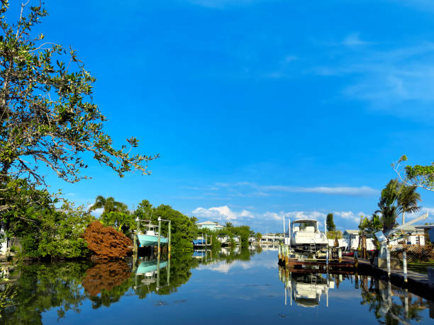 View of canal and boats over sunny sky in Anna Maria Island, Florida
