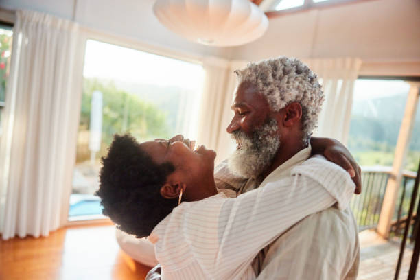 istock Laughing couple dancing together in their home with a view 1453110004