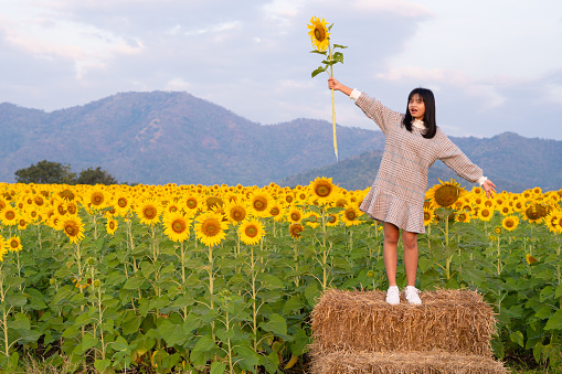 Happy young girl with flower.