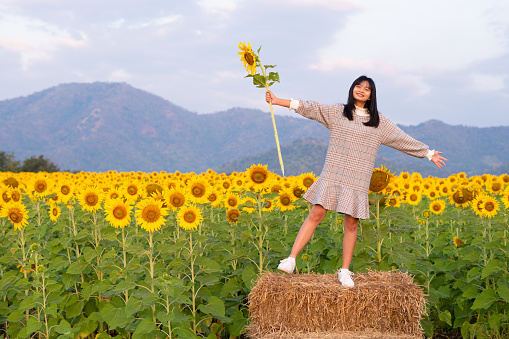 Happy young girl with flower.