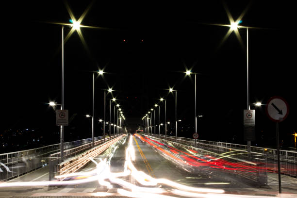 istock Car lights on a bridge at night 1453113399