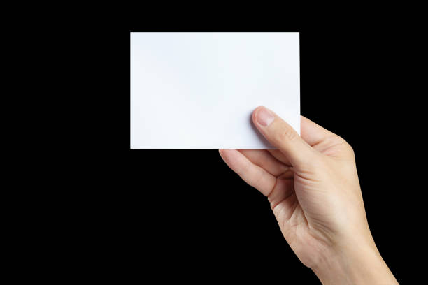 istock Hand holding blank card on black 1453114114