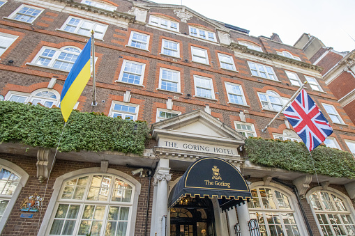 Goring Hotel, with the Ukraine flag flying in sympathy  at the Russian invasion of February 2022. Built by Otto Goring in 1910, this luxury Edwardian hotel remains in the Goring family and is run by Jeremy Goring. The hotel has hosted the commander of the US expeditionary forces (World War I), an allied meeting held by Winston Churchill, and the Polish government in exile (both World War II). Kate Middleton stayed in the Royal Suite on the night of 28 April 2011, before her wedding to Prince William the next day. Meghan Markle and Prince Harry had a private lunch there in March 2020, the first time Meghan was seen back in the UK after the Megxit announcement.