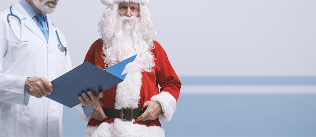 Santa Claus meeting a doctor at the hospital, healthcare and prevention concept