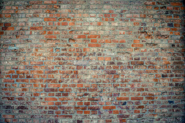 istock Old brick wall. Brickwork from an old brick in a rustic style. The structure and pattern of the destroyed stone wall. Copy space 1453117002