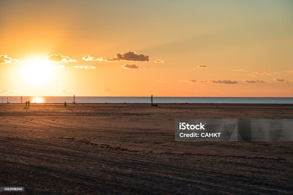 Sunset in the North Sea Sunset after ebb in the North Sea in Sank-Peter-Ording, Germany Beach Stock Photo