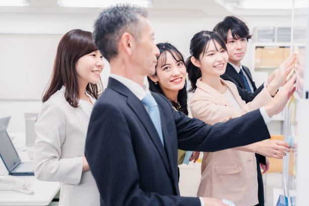 istock Business people working happily in the office 1453120079