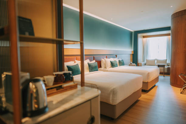 istock Modern Hotel Room With Twin Bed Suite illuminated with warm lights 1453121662