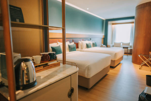 istock Modern Hotel Room With Twin Bed Suite illuminated with warm lights 1453121674