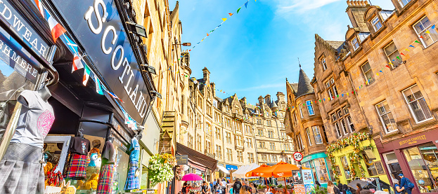 Edinburgh, Scotland - 2 September 2022: Popular tourist Cockburn street in Edinburgh old town with many souvenir shops and pubs