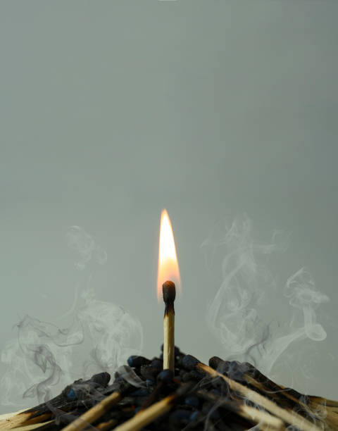 istock Group of spent matches and one last match left burning 1453124388