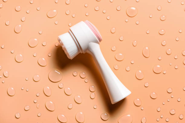 istock Facial brush and drops of liquid soap. 1453127795