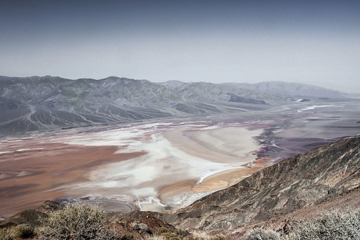 A beautiful shot of the Death valley surrounded by hills in the daytime.