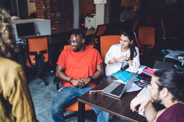 istock Serious multiethnic coworkers during conference in modern open space office 1453128279