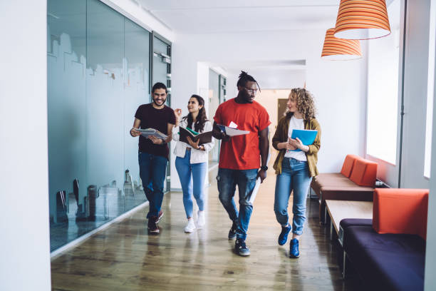 istock Business people discussing work walking at office space 1453128337