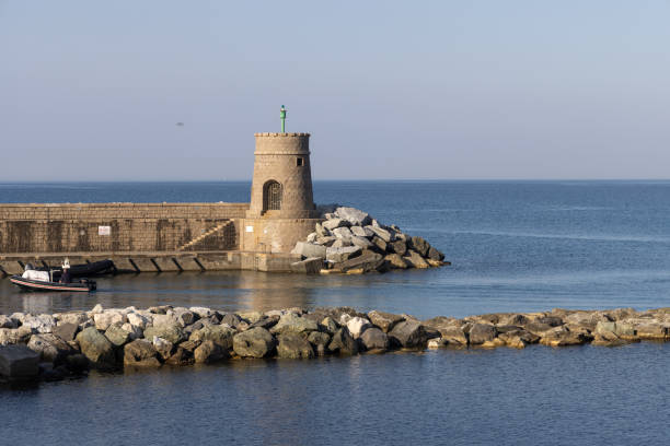 istock Old small lighthouse and stone wave breakers of Recco on a sunny summer day. Recco is a comune in the Metropolitan City of Genoa, region of Liguria, Italy. 1453128399