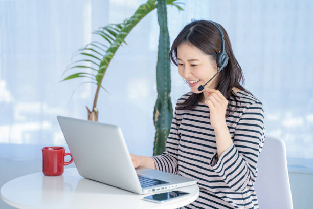 istock Woman wearing a headset and working from home. 1453130322
