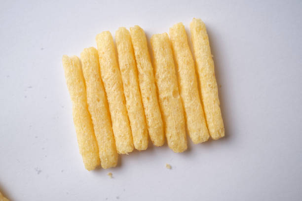 Row of potato crips against a white background.