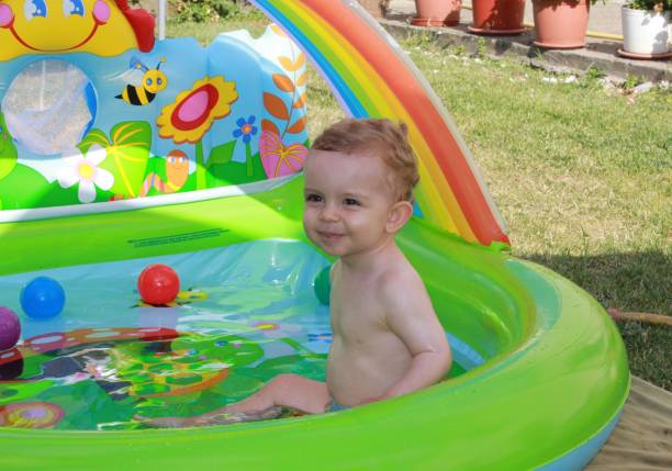 istock my one year old son having a bath in a plastic swimming pool 1453130779