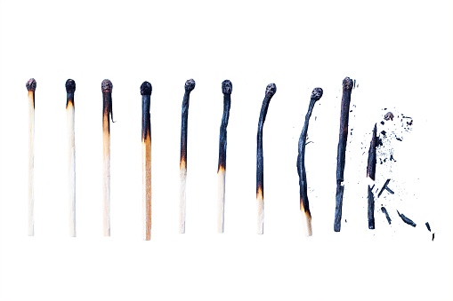 A number of wooden burned matchsticks isolated on a white background