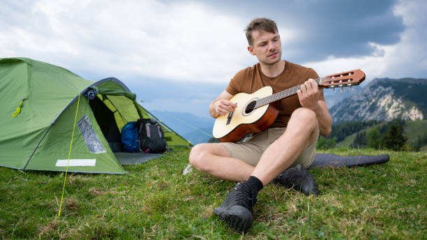 istock Young Man Camping In Mountains 1453132401