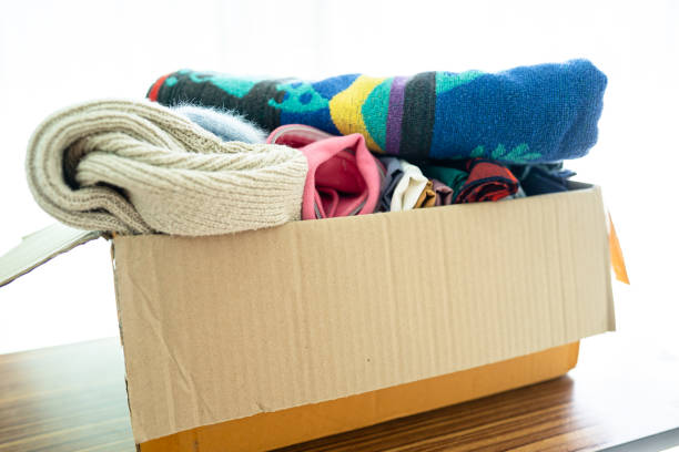istock Donation box with used clothes at home to support help for poor people in the world. 1453133676