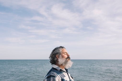 Side view portrait of a bearded man breathing fresh air