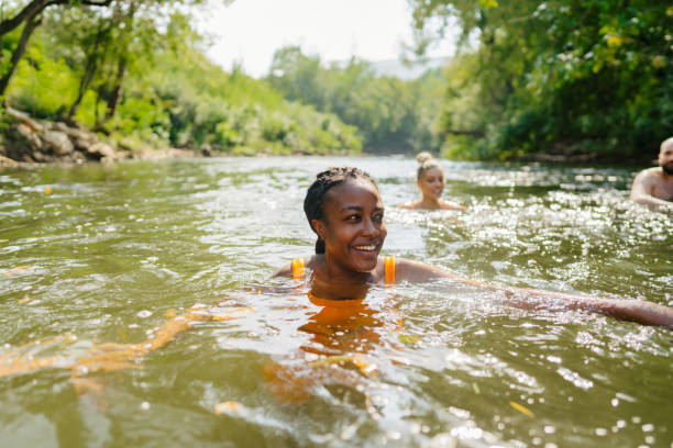 istock Smiling woman swimming in the river 1453135213