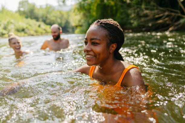 istock Smiling woman swimming in the river 1453135214