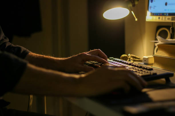 istock Male hands working overtime in office on laptop at night 1453135412