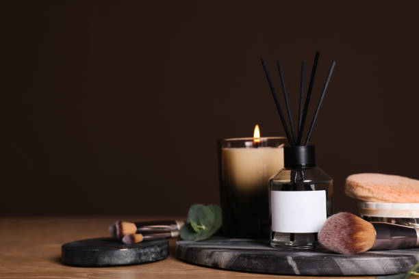 istock Composition with aromatic reed air freshener on wooden table, space for text 1453135474