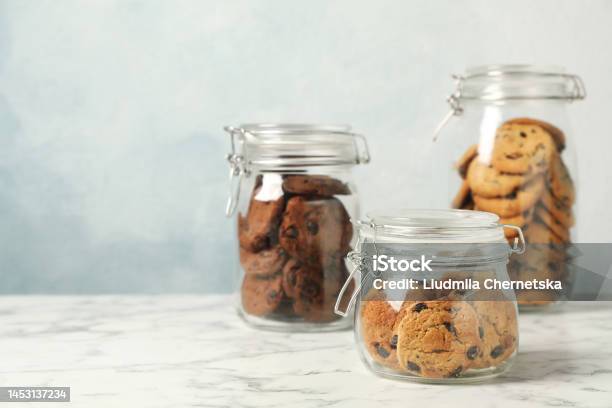 https://media.istockphoto.com/id/1453137234/photo/delicious-chocolate-chip-cookies-in-glass-jars-on-white-marble-table-space-for-text.jpg?s=612x612&w=is&k=20&c=4XV0Wg09nXy-0YBT1AZBob45pDeCW_X5XiKtXcwewNQ=