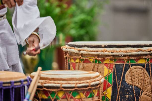 istock African drummer holding drumsticks and playing on the park on a sunny day 1453137933