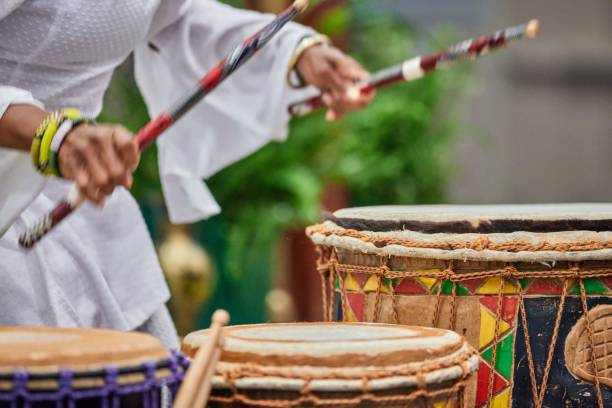 istock African drummer holding drumsticks and playing on the park on a sunny day 1453137935