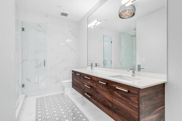 istock A bathroom with a wood cabinet, marble shower, and pattern tile floor. 1453138323