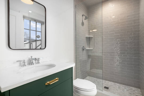 istock A white bathroom with a green cabinet and subway tile shower. 1453138921