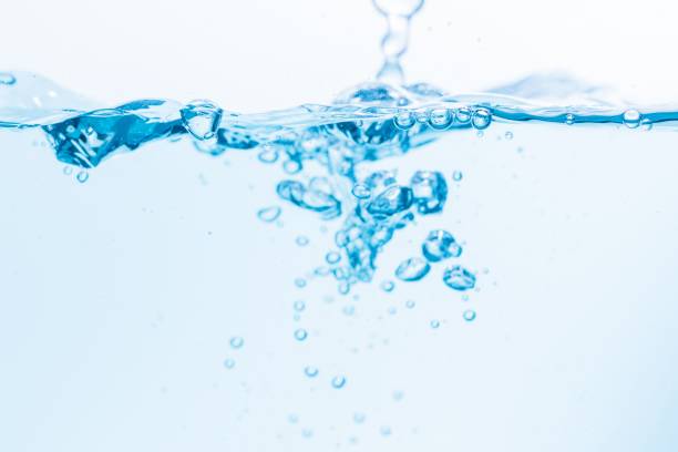 istock Surface of the blue water waves splash on a white background 1453139313