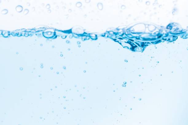 istock Surface of the blue water waves splash on a white background 1453139315