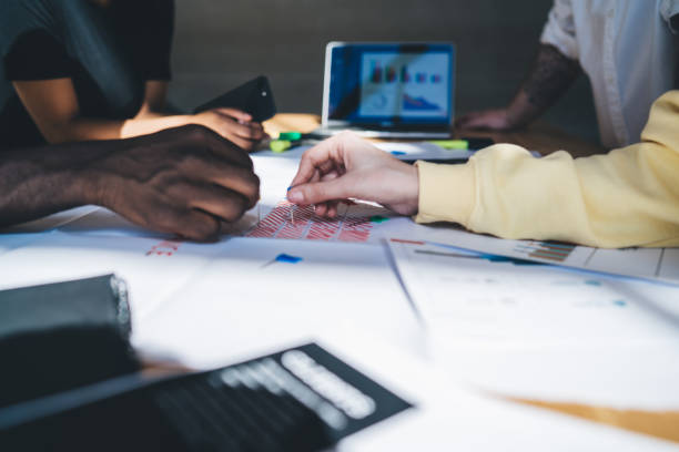 istock Multiracial people drawing together and working at table 1453139346