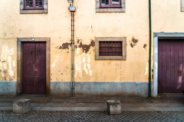 Old house wall with cracked bricks in Porto