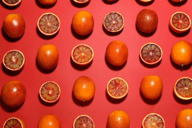 istock Many ripe sicilian oranges on red background, flat lay 1453141940