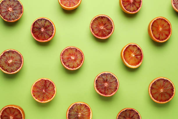istock Many ripe sicilian oranges on light green background, flat lay 1453142473