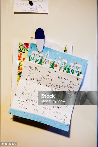 Modern Refrigerator Door With Childs Notes And Magnets In Kitchen Stock Photo - Download Image Now