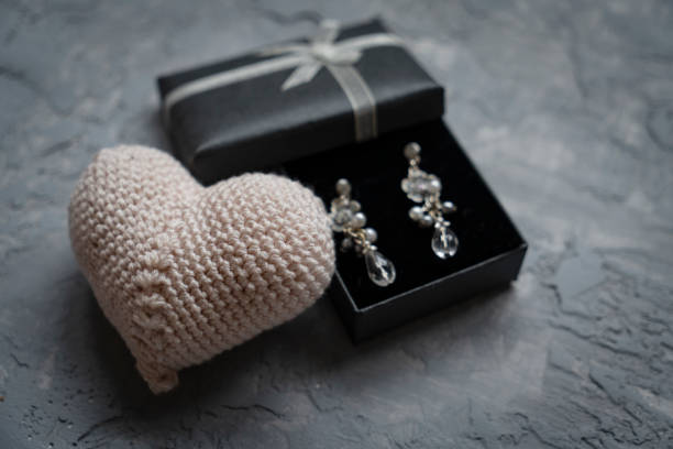 Earring in gift box with ribbon