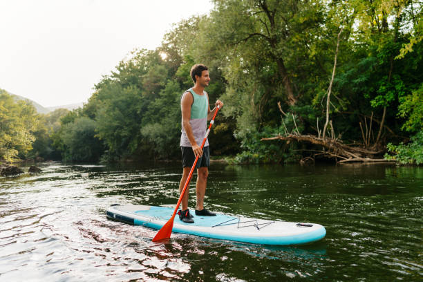 Paddleboarding on the river stock photo